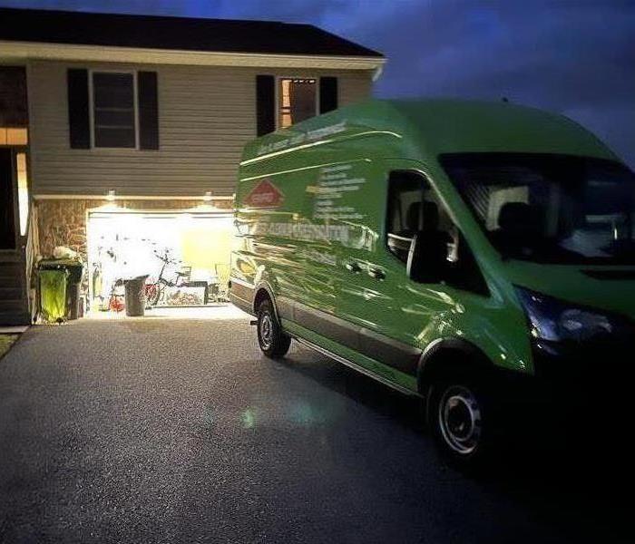 SERVPRO van parked in front of a house at night