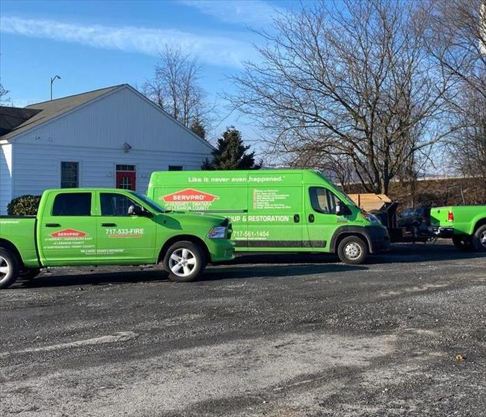 Three SERVPRO vehicles parked in front of a church