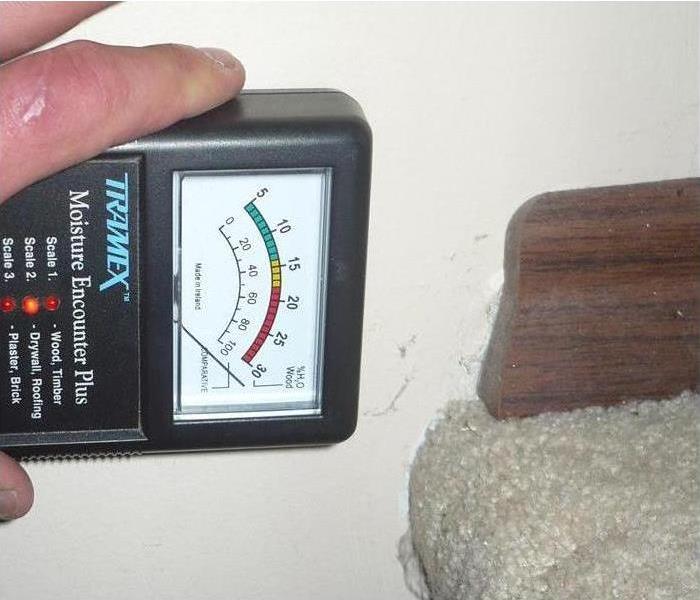 Moisture meter up against a wall